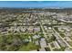 Aerial view of community with homes, pool, and ocean view at 1402 Grand Blvd # 240, Sarasota, FL 34232