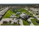 Aerial view of community pool, clubhouse, and surrounding homes at 1402 Grand Blvd # 240, Sarasota, FL 34232