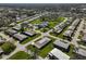 Aerial view of community with numerous homes, lush landscaping, and a pool at 1402 Grand Blvd # 240, Sarasota, FL 34232