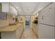 Well-equipped kitchen, granite counters, and white cabinets at 1402 Grand Blvd # 240, Sarasota, FL 34232
