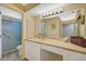 Well-lit bathroom with double sinks and a large mirror at 1402 Grand Blvd # 240, Sarasota, FL 34232