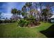 Landscaped garden with palm trees and tropical plants at 719 Brightside Crescent, Venice, FL 34293