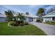 Single story home with a white roof and lush landscaping at 719 Brightside Crescent, Venice, FL 34293