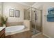 Bathroom with soaking tub and walk-in shower at 11723 Breadfruit Ln, Venice, FL 34292