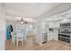 Bright dining area with white table and chairs, near kitchen at 1019 Beach Manor Ctr # 35, Venice, FL 34285