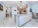Modern kitchen boasts white cabinets, granite counters, and stainless steel appliances at 147 Tampa E Ave # 202, Venice, FL 34285