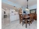Open concept dining room with a large wooden table, adjacent to the kitchen at 147 Tampa E Ave # 202, Venice, FL 34285