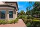 Landscaped walkway leading to the side entrance of the townhome at 10055 Crooked Creek Dr # 103, Venice, FL 34293