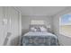 Cozy bedroom with a full-size bed and built-in shelving at 116 Caddy Rd, Rotonda West, FL 33947