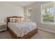Bedroom with wicker bed and two windows at 11925 Bohemian Pl, Venice, FL 34293