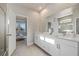 Double vanity bathroom with a large mirror and shower at 11925 Bohemian Pl, Venice, FL 34293