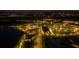 Night aerial view of a town center with lake and street lights at 11925 Bohemian Pl, Venice, FL 34293