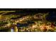 Night aerial view of a town center with shops and a park at 11925 Bohemian Pl, Venice, FL 34293