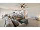 Spacious living room with large sectional sofa and ceiling fan at 11925 Bohemian Pl, Venice, FL 34293