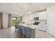 Modern kitchen with white cabinets and island at 11925 Bohemian Pl, Venice, FL 34293