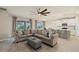 Spacious living room with large sectional sofa and tile flooring at 11925 Bohemian Pl, Venice, FL 34293