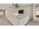 Open living room with sectional sofa and backyard view at 11925 Bohemian Pl, Venice, FL 34293