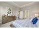Main bedroom with large bed and ensuite bathroom access at 11925 Bohemian Pl, Venice, FL 34293