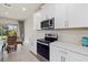 Modern kitchen features stainless steel appliances and white shaker cabinets at 11925 Bohemian Pl, Venice, FL 34293