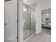 Bathroom with a large glass shower and grey tile at 11925 Bohemian Pl, Venice, FL 34293