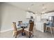 Bright dining area with glass table and wicker chairs, near kitchen at 11925 Bohemian Pl, Venice, FL 34293