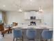 Modern kitchen with white cabinets, large island, and stainless steel appliances at 11925 Bohemian Pl, Venice, FL 34293
