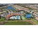 Aerial view of community with pool, tennis courts, and playground at 11925 Bohemian Pl, Venice, FL 34293