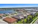 Community overview showcasing lake, numerous homes and landscaping at 11925 Bohemian Pl, Venice, FL 34293