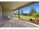 Covered patio with paver stones and view of the backyard at 11925 Bohemian Pl, Venice, FL 34293