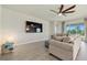 Relaxing living room with sectional sofa and access to backyard at 11925 Bohemian Pl, Venice, FL 34293