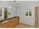 Bathroom with double sinks, granite countertops, and modern fixtures at 1219 Nantucket Rd, Venice, FL 34293