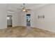 Bedroom with tile flooring, ceiling fan, and sliding doors to a screened lanai and pool at 1219 Nantucket Rd, Venice, FL 34293