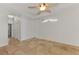 Bedroom with tile flooring, a ceiling fan, and access to a walk-in closet and bathroom at 1219 Nantucket Rd, Venice, FL 34293