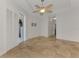 Open bedroom featuring tile floors, a ceiling fan, and sliding doors at 1219 Nantucket Rd, Venice, FL 34293