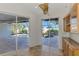 Bright breakfast nook featuring sliding glass doors with views of the screened-in pool and backyard at 1219 Nantucket Rd, Venice, FL 34293