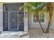 Front entry with decorative screen door and landscaping at 1219 Nantucket Rd, Venice, FL 34293