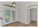 Bright foyer features double front doors with decorative glass and neutral tile flooring at 1219 Nantucket Rd, Venice, FL 34293