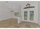 This spacious entry foyer features decorative glass double doors and neutral tile flooring at 1219 Nantucket Rd, Venice, FL 34293