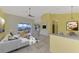 Bright living room with vaulted ceilings, tile floors, and access to the pool area at 1219 Nantucket Rd, Venice, FL 34293