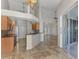Modern kitchen features stainless steel appliances, breakfast bar, and an open view of the living area at 1219 Nantucket Rd, Venice, FL 34293