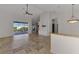 Open living area featuring tile floors, a ceiling fan and a view of the screened in pool at 1219 Nantucket Rd, Venice, FL 34293