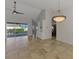 Open living area featuring tile floors, a ceiling fan and view of the screened-in pool at 1219 Nantucket Rd, Venice, FL 34293