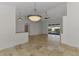 This open living area features neutral tile floors, modern lighting, and views of the pool area at 1219 Nantucket Rd, Venice, FL 34293