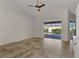 Bright living room featuring tile floors and sliding glass doors to the screened-in lanai at 1219 Nantucket Rd, Venice, FL 34293