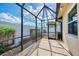 Screened-in patio area with a generator and tiled flooring with access to backyard at 1219 Nantucket Rd, Venice, FL 34293