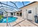 Enclosed pool with attached spa and outdoor access doors and hose reel at 1219 Nantucket Rd, Venice, FL 34293
