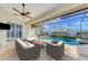 Covered patio with seating overlooking pool and screened enclosure at 1219 Nantucket Rd, Venice, FL 34293