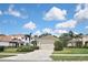 Two-story home with tile roof, attached garage, and manicured lawn at 12236 Stuart Dr, Venice, FL 34293