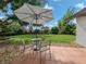 Relaxing patio area with umbrella, table, and chairs, perfect for outdoor dining at 1238 Waterside Ln, Venice, FL 34285