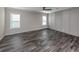 Large bedroom with neutral walls, hardwood floors and ceiling fan at 127 Nautical Dr, North Port, FL 34287